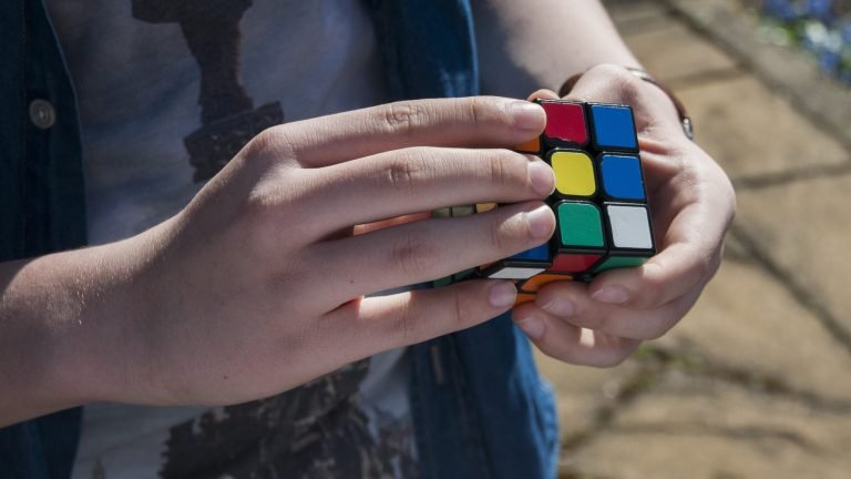 Man solving rubiks cube